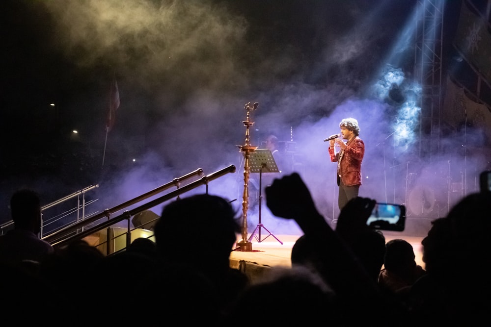 man in black jacket standing on the stage