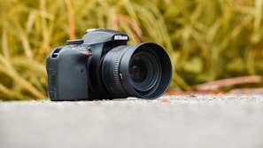 A stunning Nikon camera set against a blurred nature background.