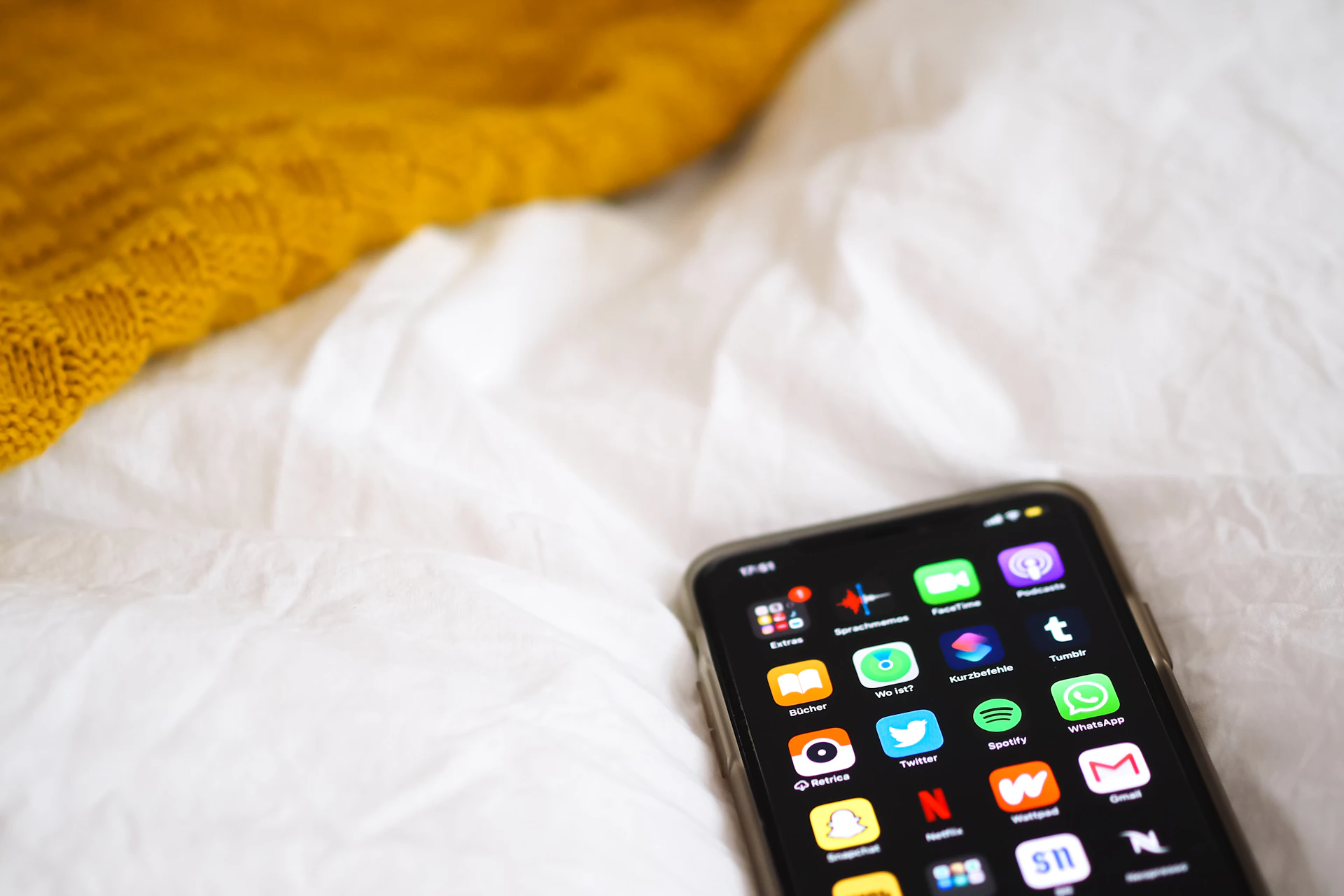 black iphone 5 on white textile