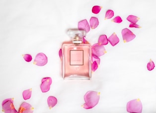 perfume bottle with pink petals