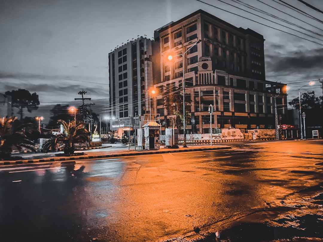 people walking on street near high rise buildings during night time