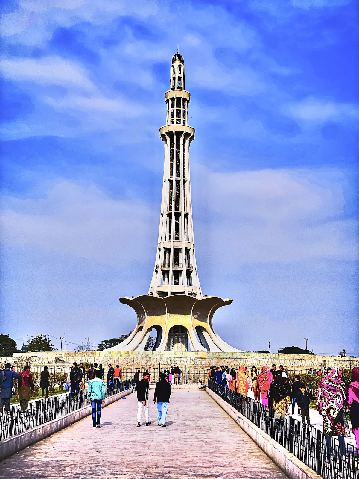 People walking near Minar-e-Pakistan, a national monument in Lahore, Pakistan