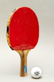 red and yellow wooden table tennis racket