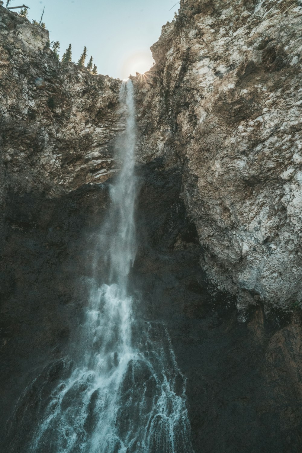 waterfalls on rocky mountain during daytime