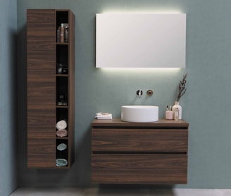 white ceramic sink beside brown wooden cabinet