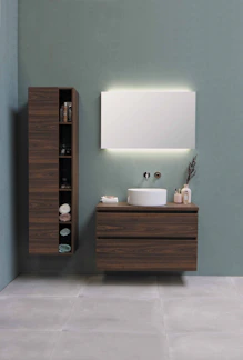 A sleek modern mirror wall cabinet with integrated LED lighting in a minimalist bathroom setting.
