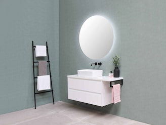Bathroom accessories including towel racks and soap dispensers arranged neatly on a vanity.