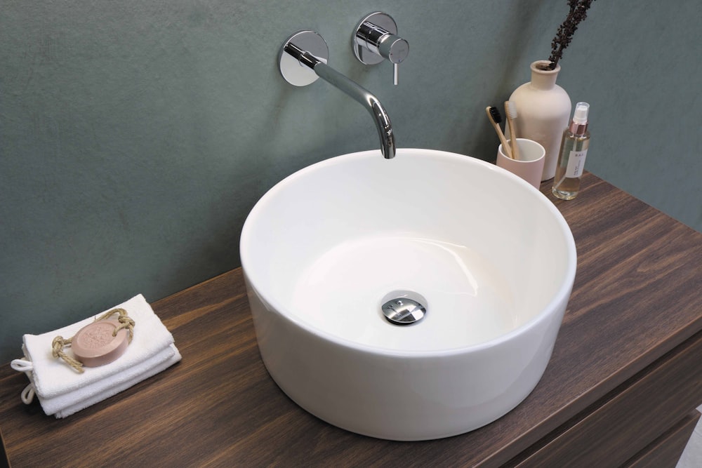 white ceramic sink with stainless steel faucet