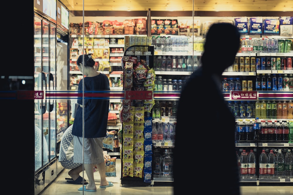 man and woman standing in front of store