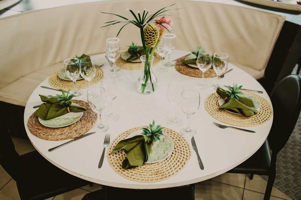 green cactus in clear glass vase on white round table