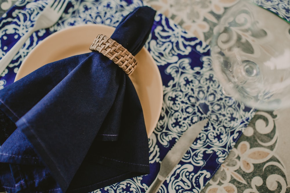 a blue and white place setting with a napkin and napkin