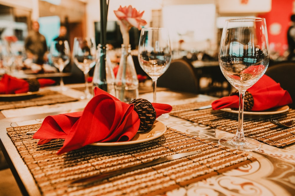 red ribbon on clear wine glass