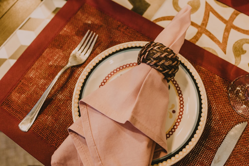 stainless steel fork and knife on white ceramic plate