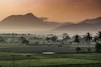 green grass field near mountain during daytime