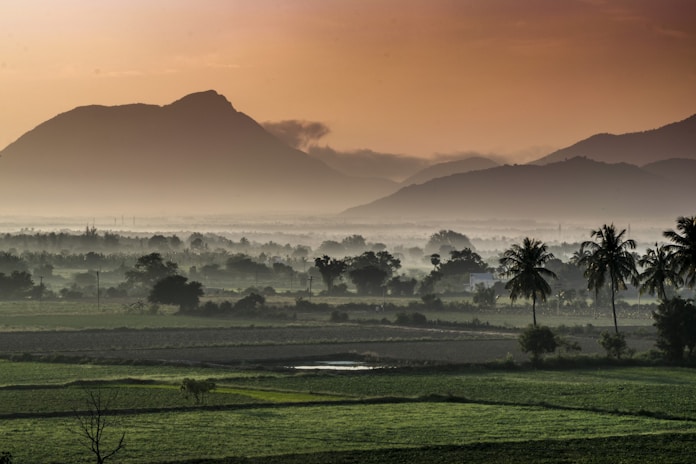 green grass field near mountain during daytime