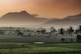 green grass field near mountain during daytime