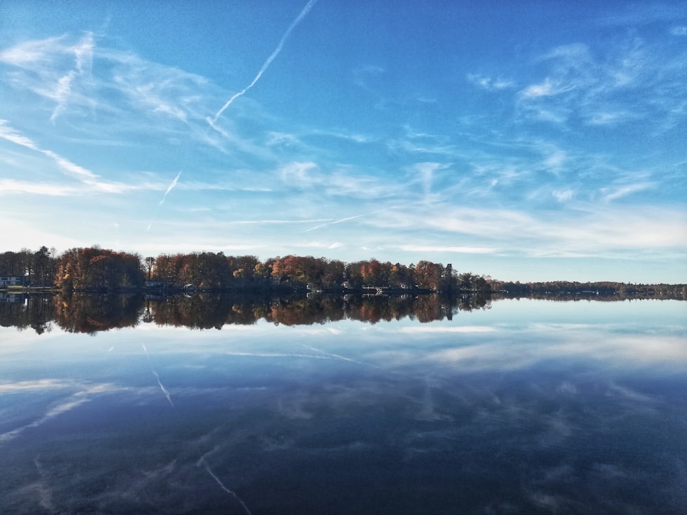 낮에는 푸른 하늘 아래 호수에 있는 갈색 나무 선착장