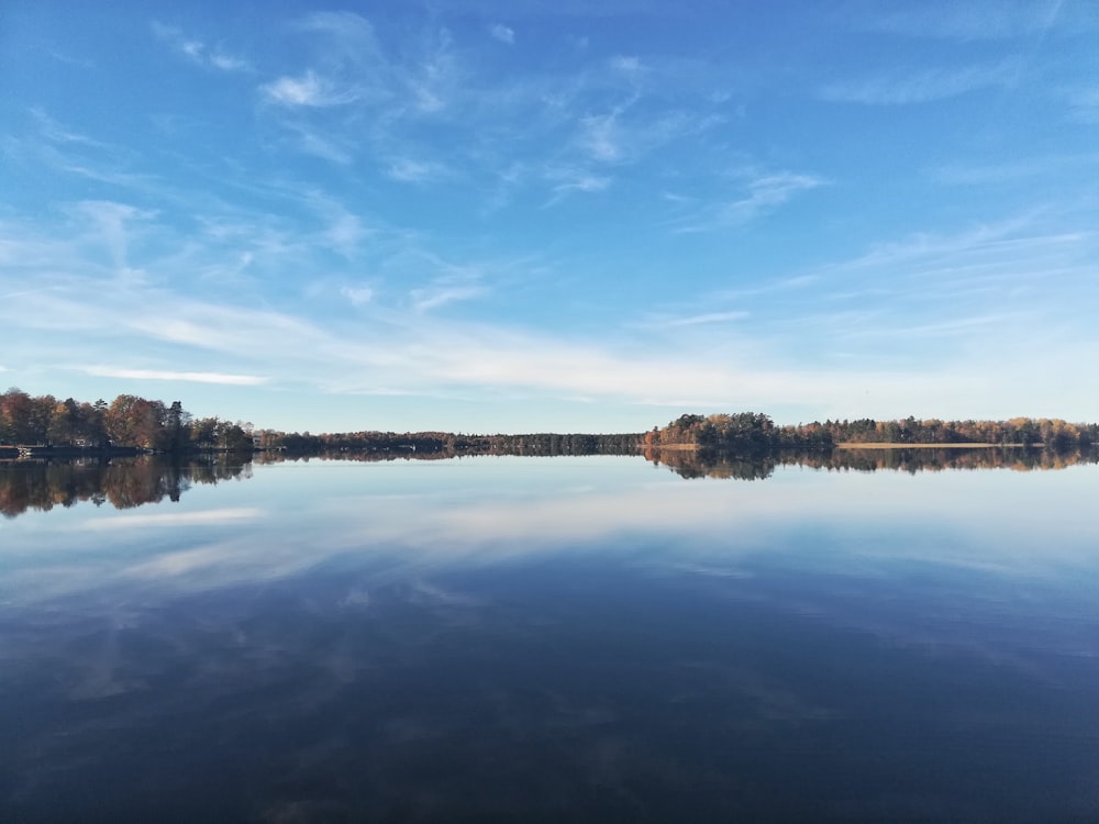 body of water near building under blue sky during daytime