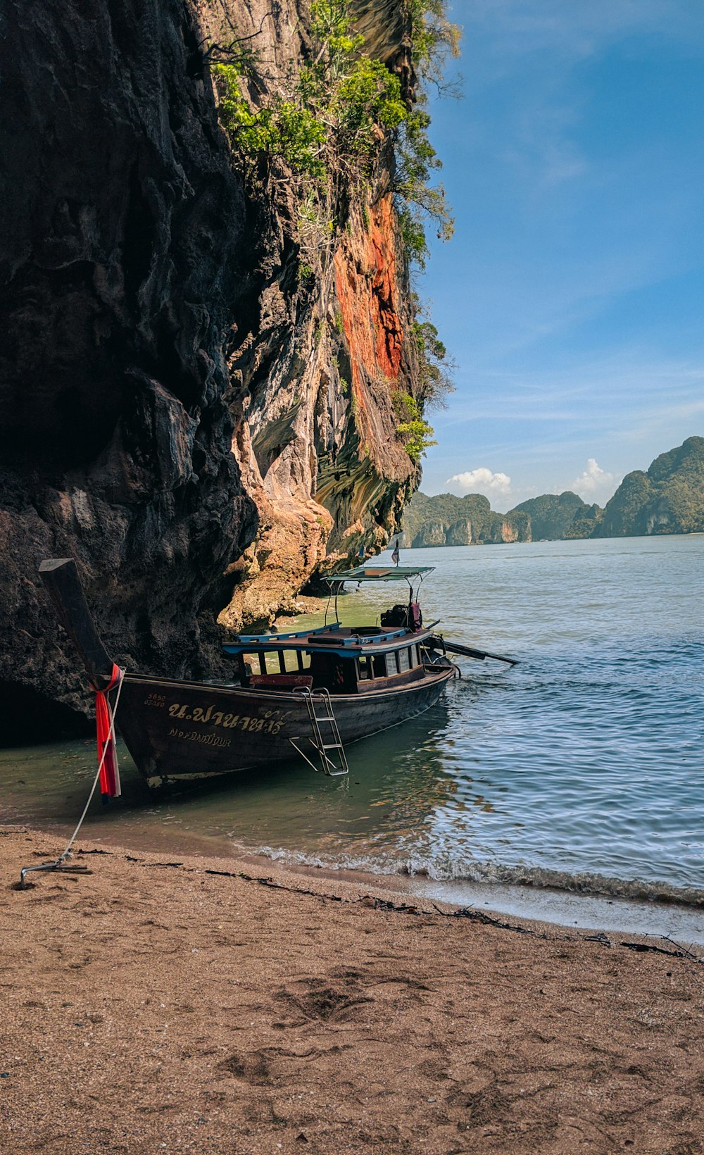 brown boat on sea shore during daytime