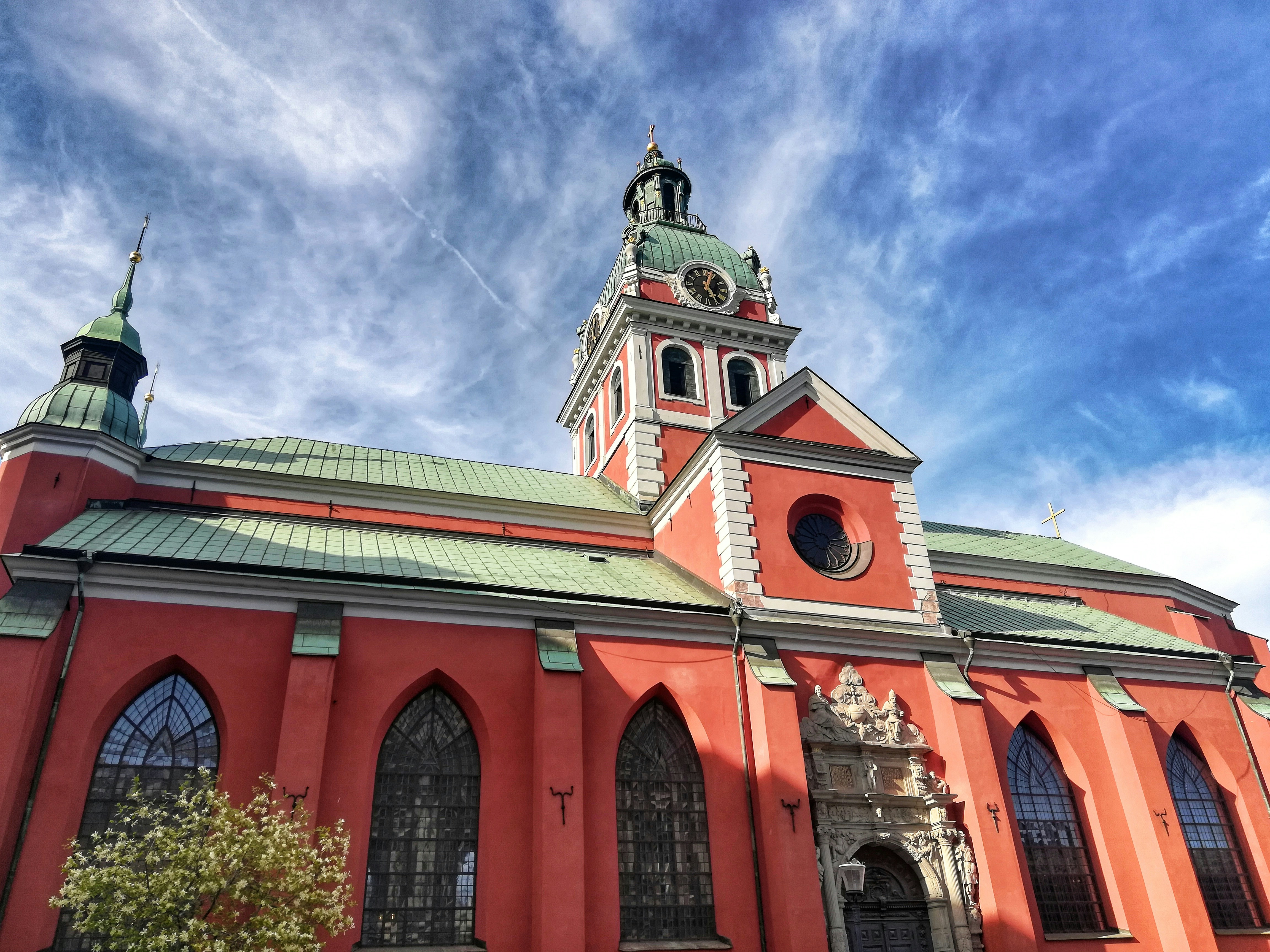 brown and black concrete building under blue sky