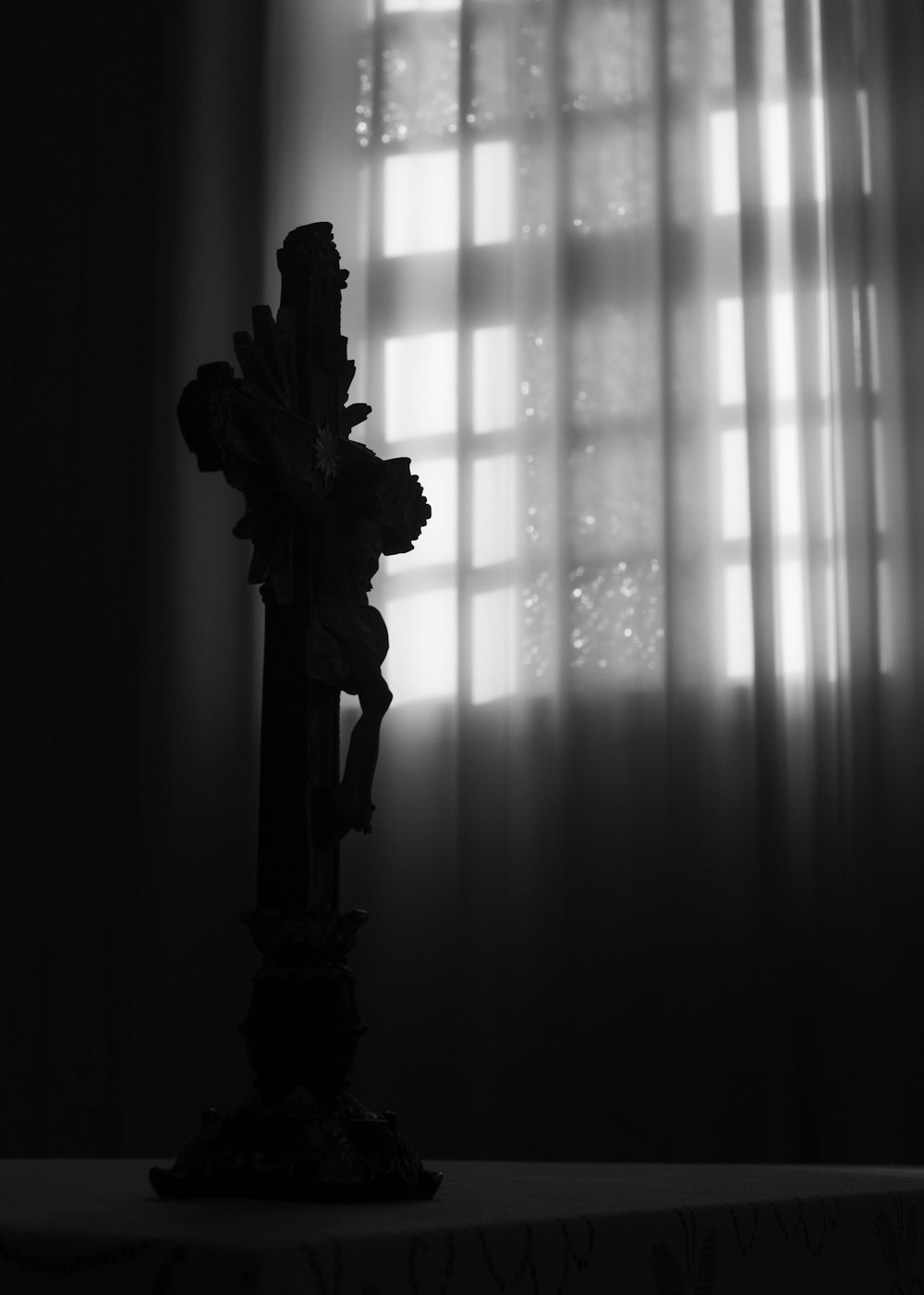 grayscale photo of flower in vase on window