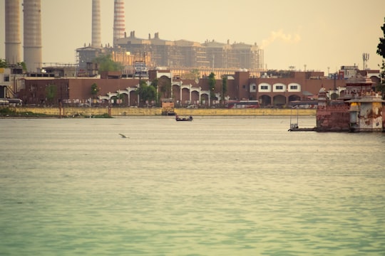 people riding boat on sea near high rise buildings during daytime in Kota India