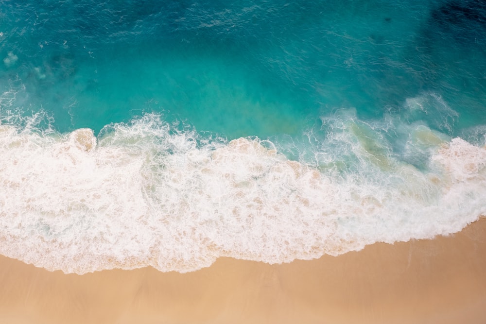 ocean waves crashing on shore during daytime