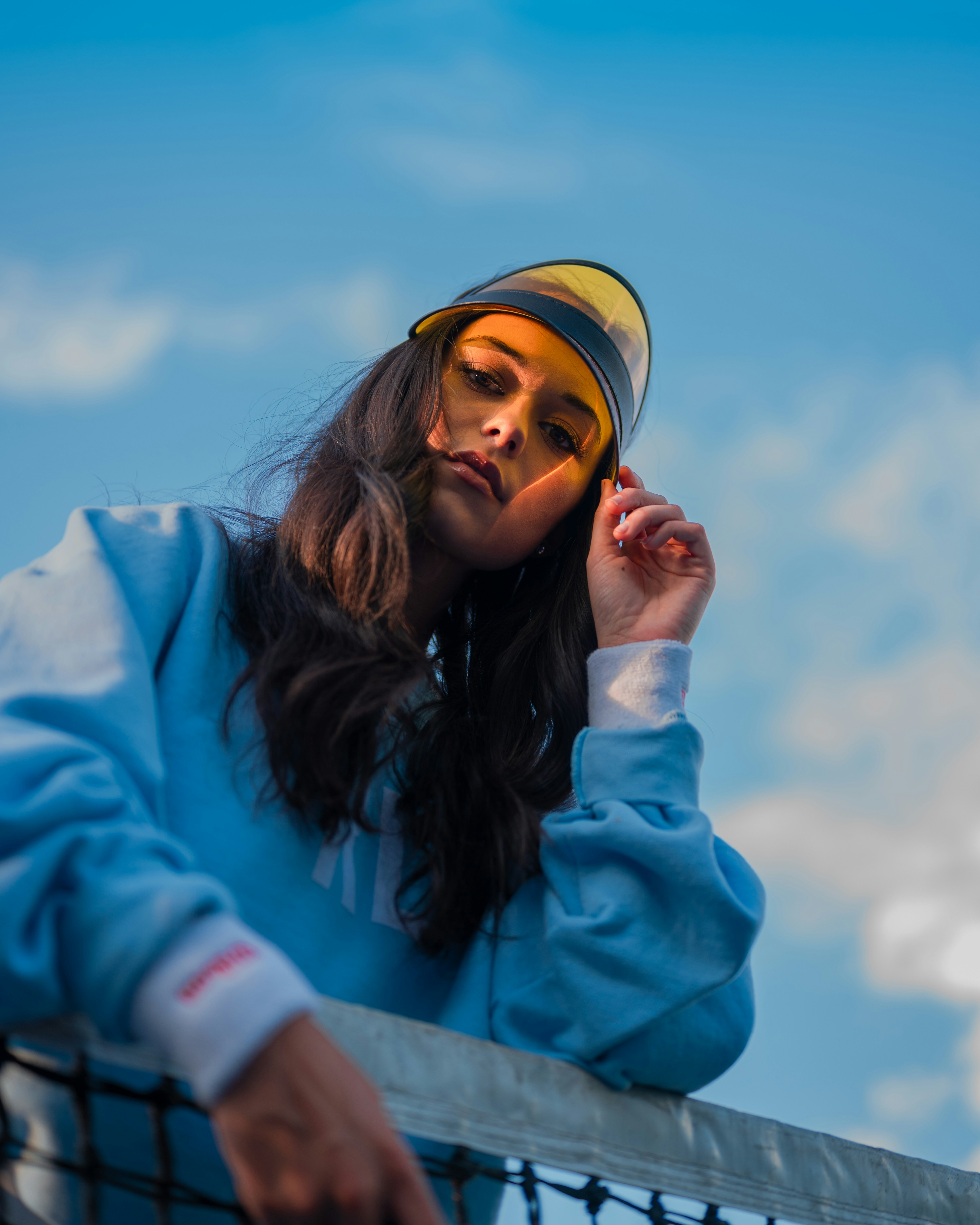 woman in blue jacket and yellow cap