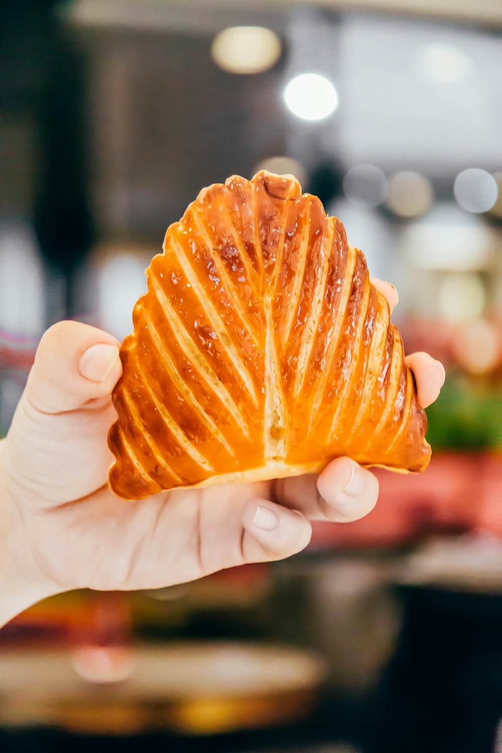 person holding a brown pastry