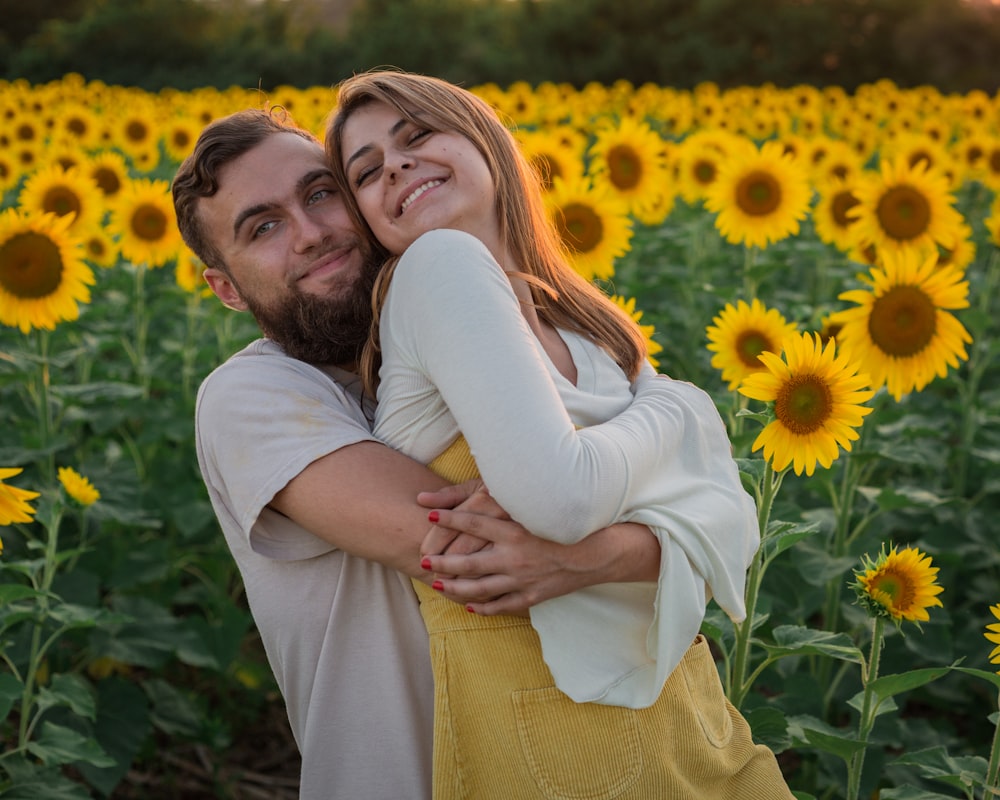 man in white dress shirt hugging woman in yellow dress