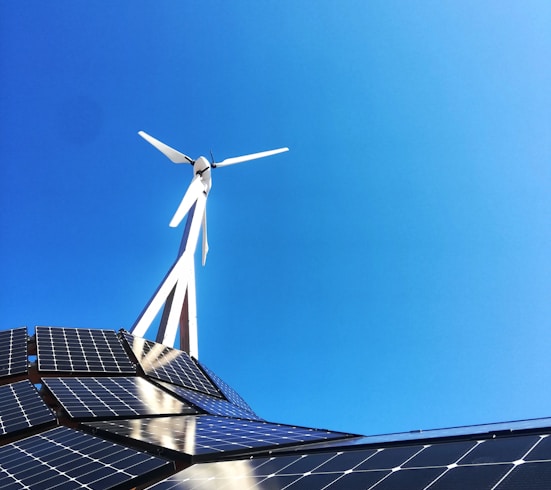 white wind turbine on top of a building