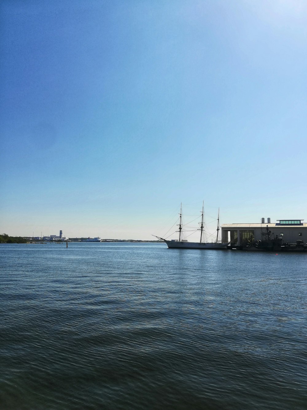 white and black ship on sea under blue sky during daytime