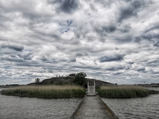 brown wooden dock on river under cloudy sky during daytime in Karlskrona Sweden
