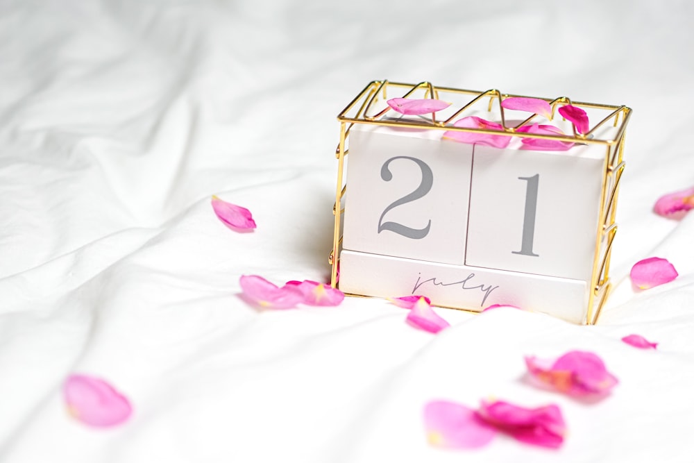 white and pink floral box on white textile