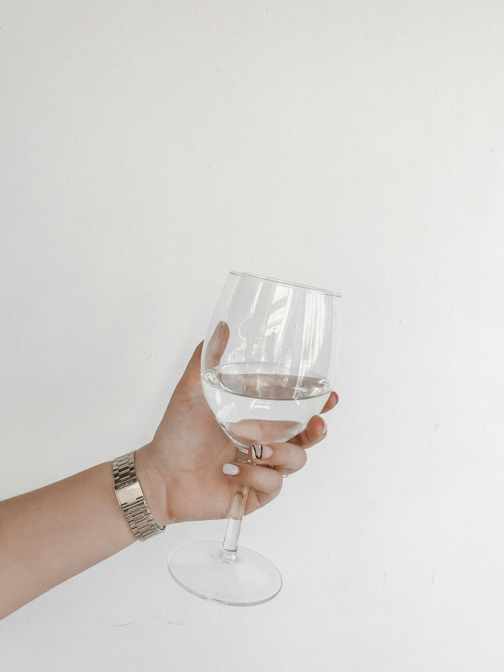 person holding clear wine glass