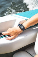 A guide demonstrating sonar technology on a tablet while the boat floats quietly on the water.