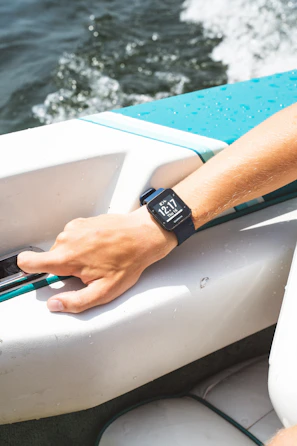 A guide demonstrating sonar technology on a tablet while the boat floats quietly on the water.
