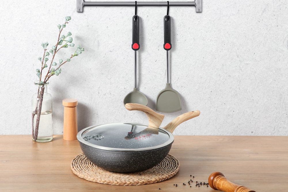 black and white ceramic bowl on brown wooden chopping board