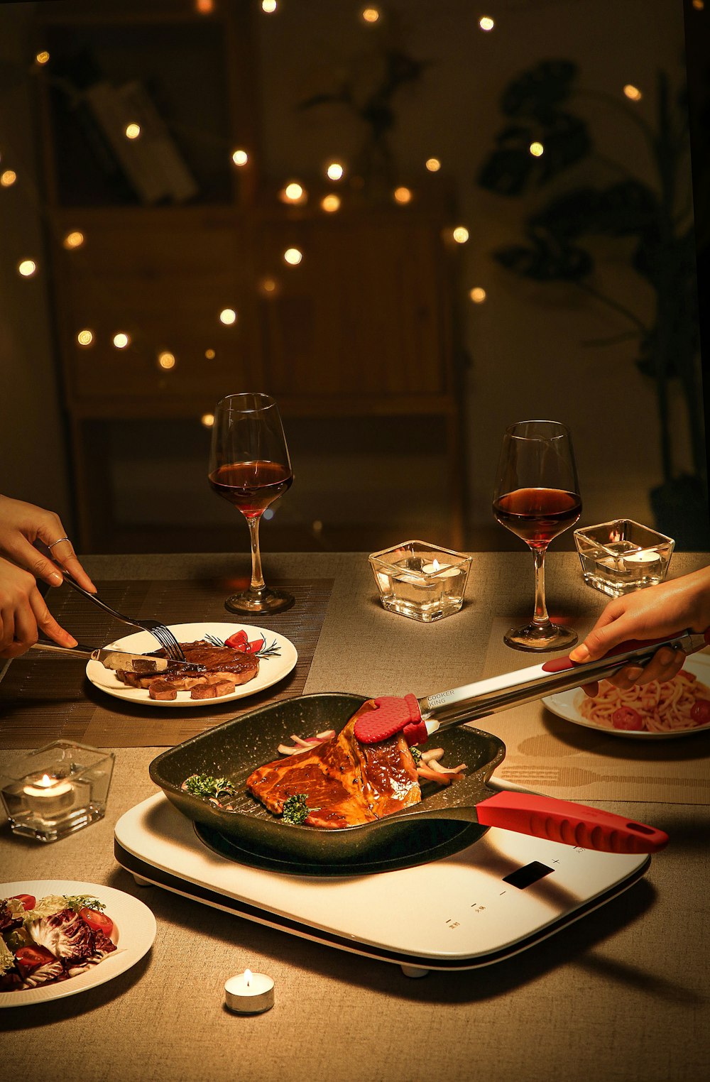 person holding fork and knife slicing pizza on plate