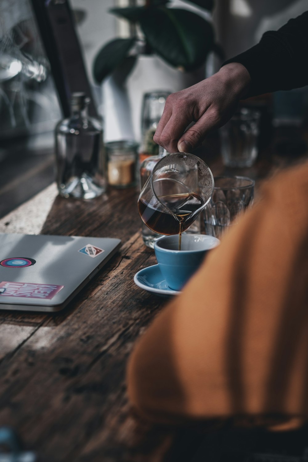 person holding clear glass cup