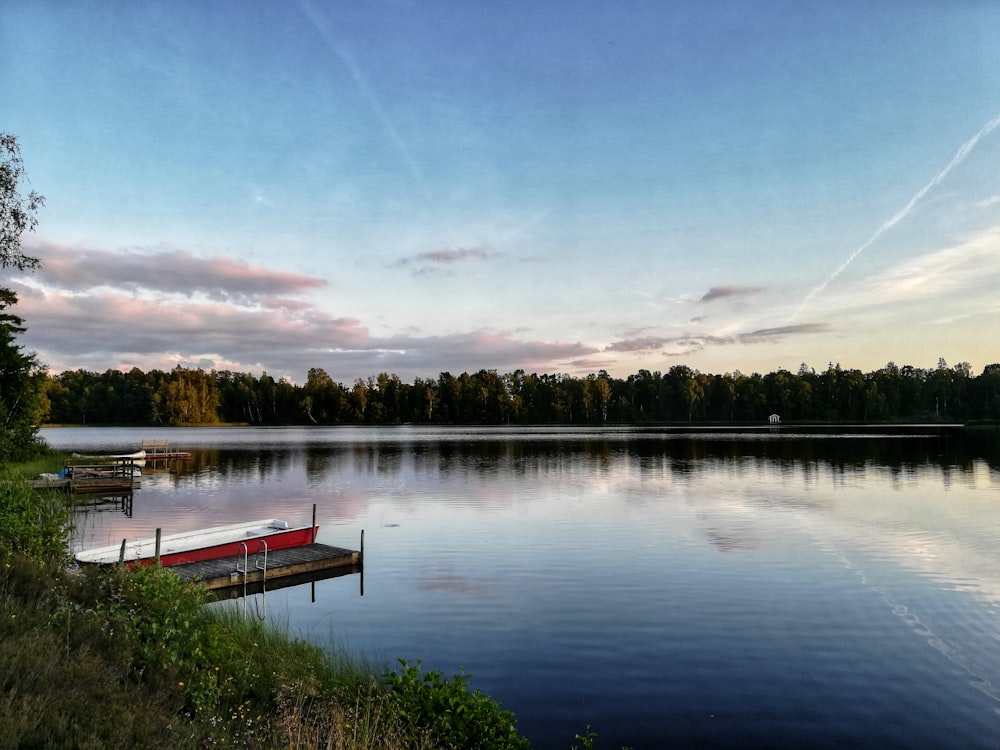 red boat on lake during daytime