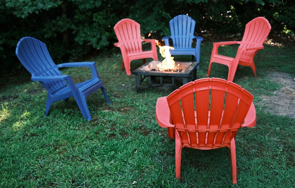 red plastic armchair on green grass field