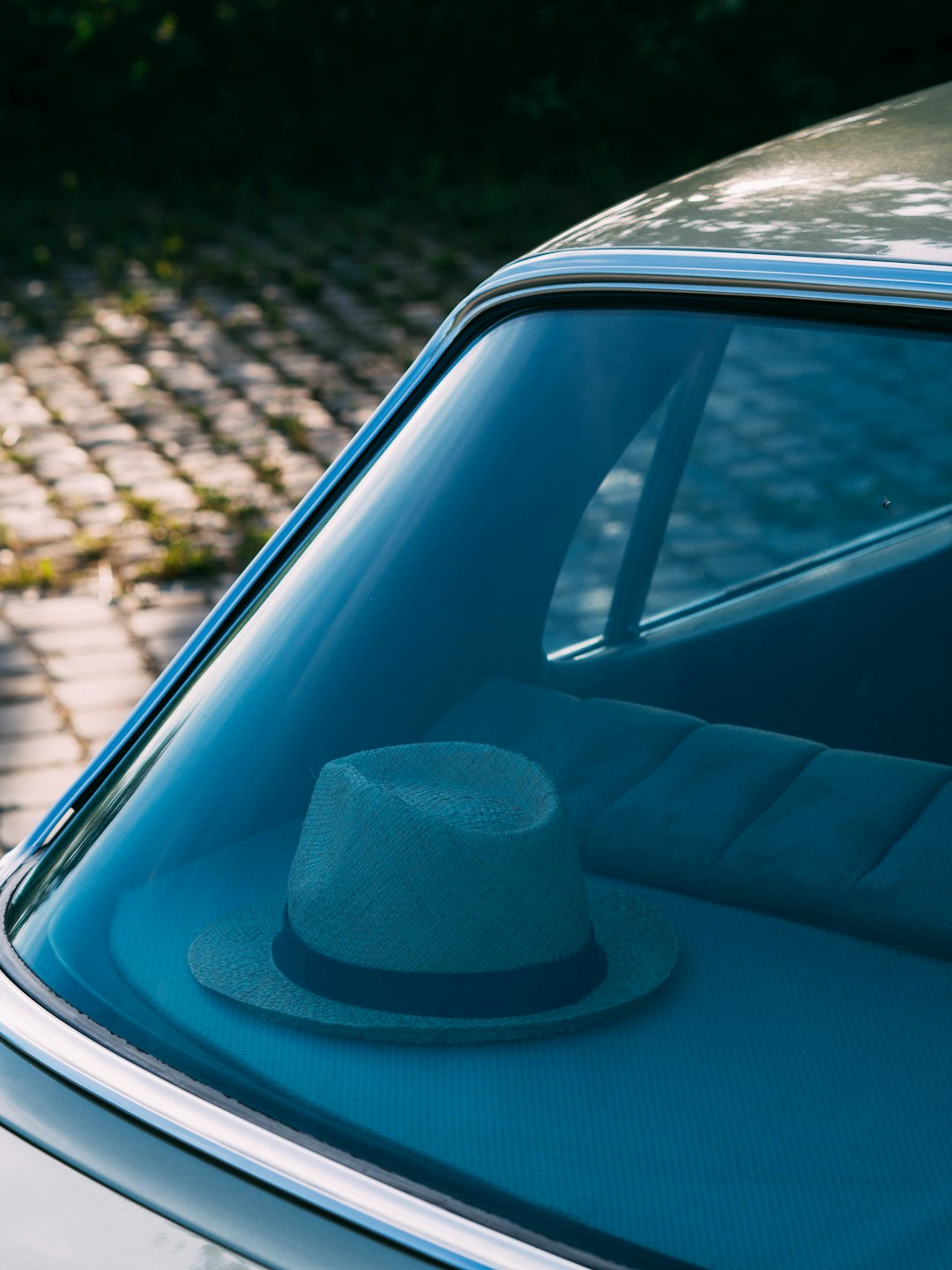 blue fedora hat on car