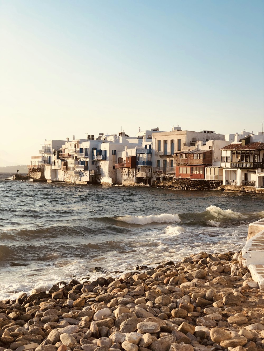 brown concrete buildings near sea during daytime