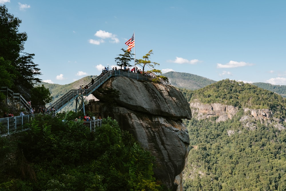 people on a mountain with flags during daytime