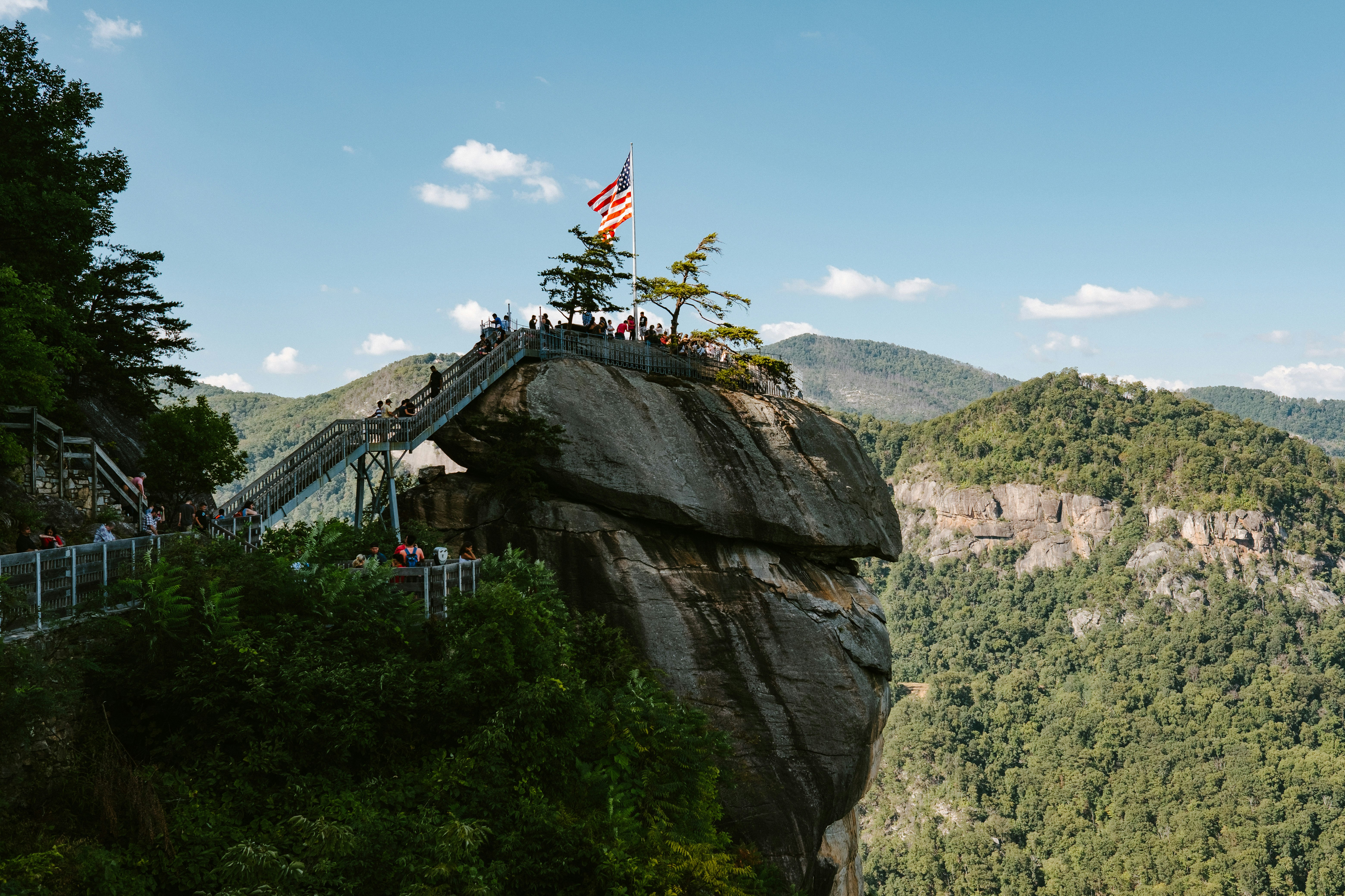 people on a mountain with flags during daytime