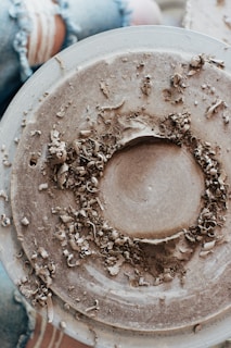 brown powder in white round container