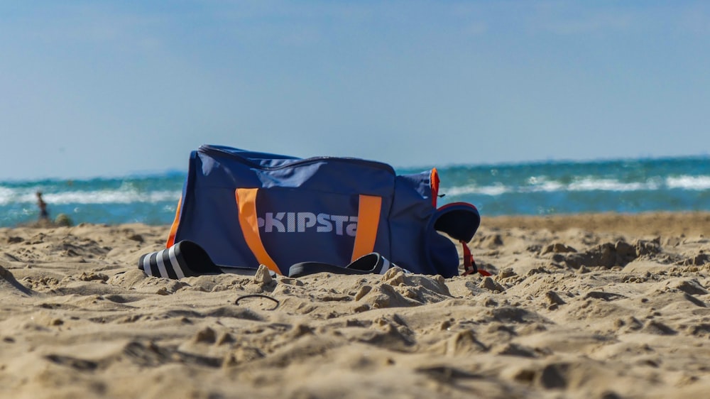 blue and white adidas bag on beach during daytime