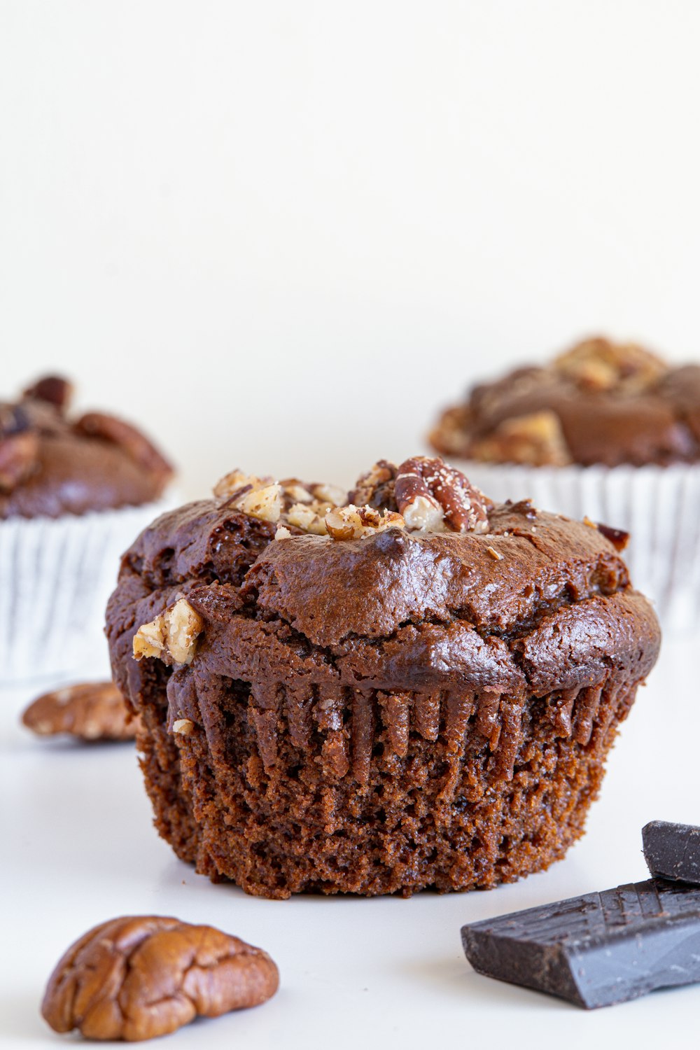 a close up of a chocolate cupcake with nuts