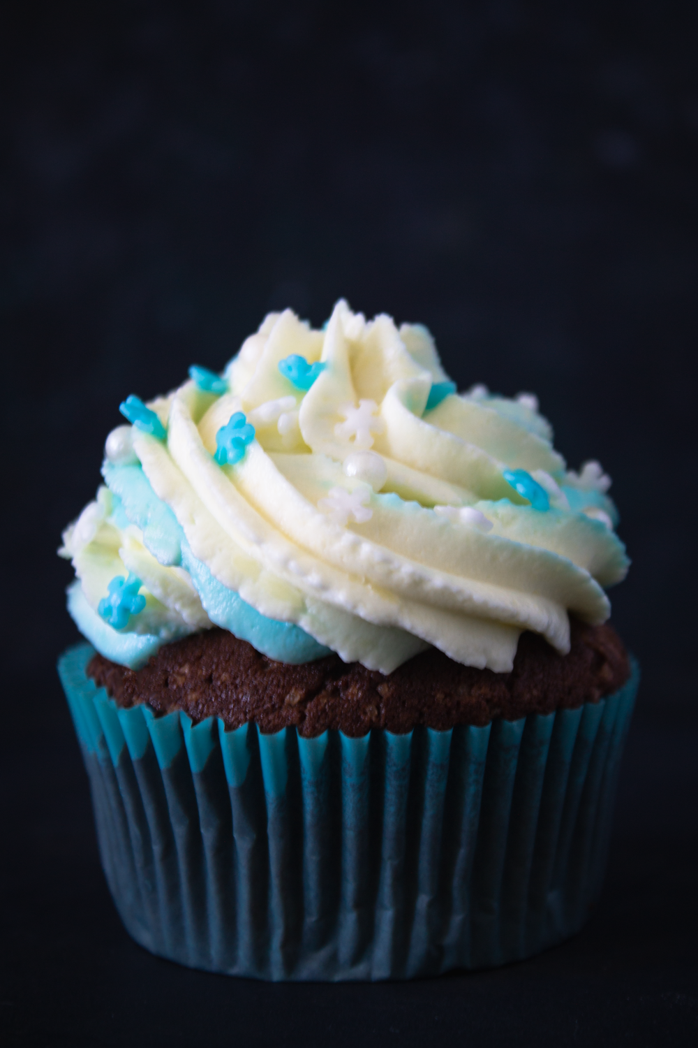 white and brown cupcake with white icing on top